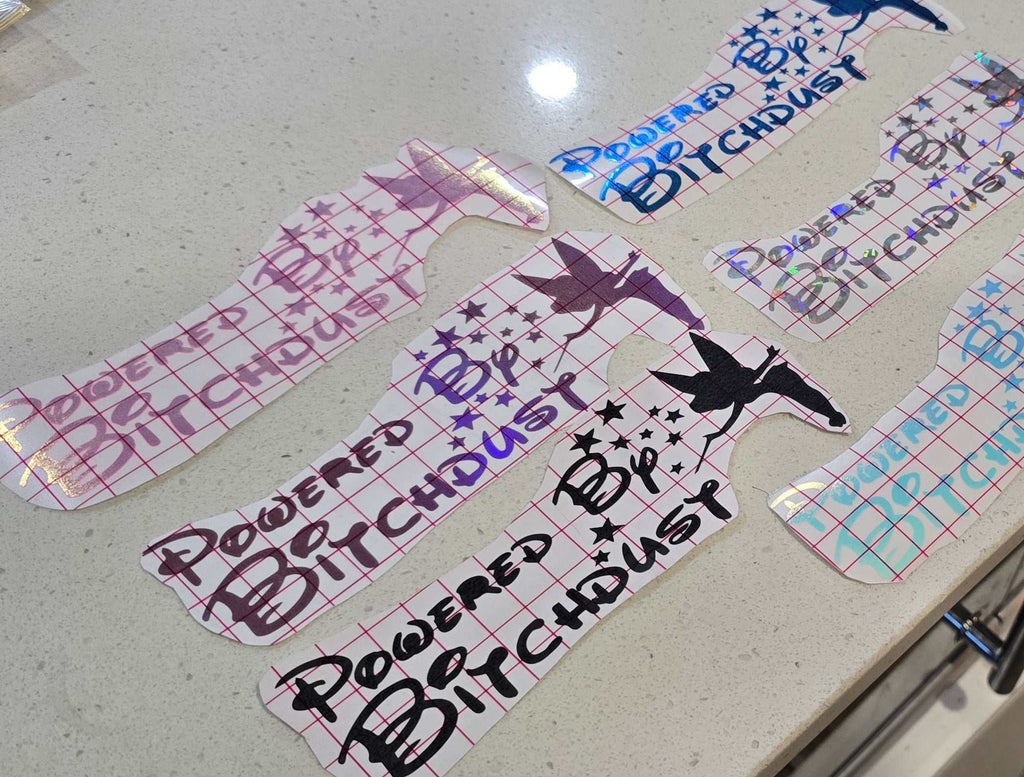 Glossy "Powered by Bitchdust" decal with sparkly finish, weather-resistant vinyl for cars and laptops