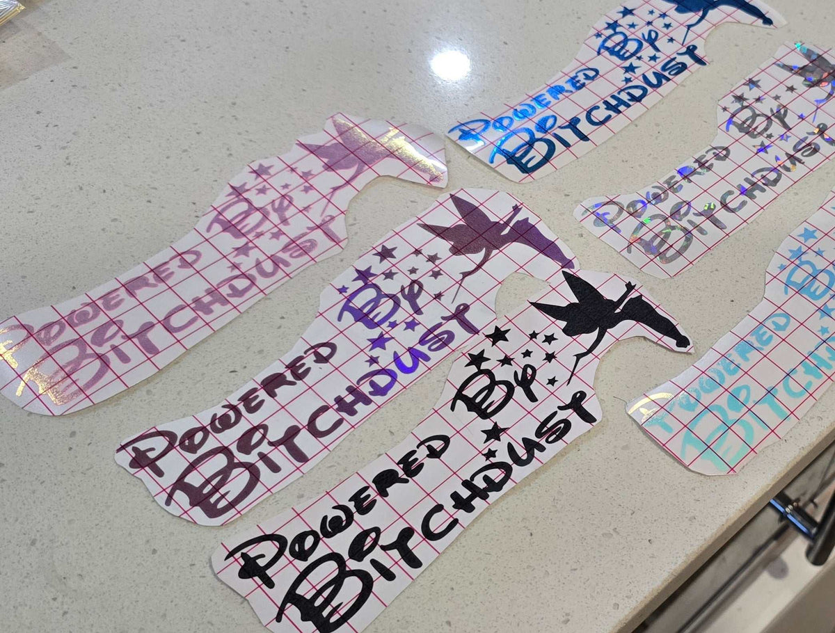 Glossy "Powered by Bitchdust" decal with sparkly finish, weather-resistant vinyl for cars and laptops