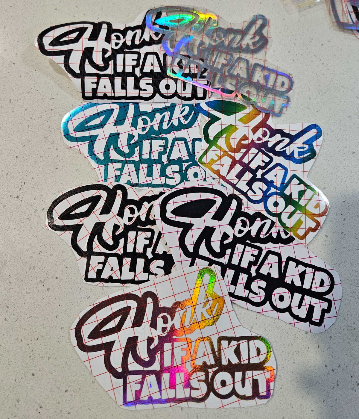 Car decal with text "Honk If A Kid Falls Out" for humorous parenting message on family vehicles
